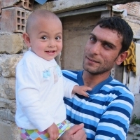 Father and son in Albania. (Photo courtesy of Jhpiego.) Father and son in Albania. (Photo courtesy of Jhpiego.)