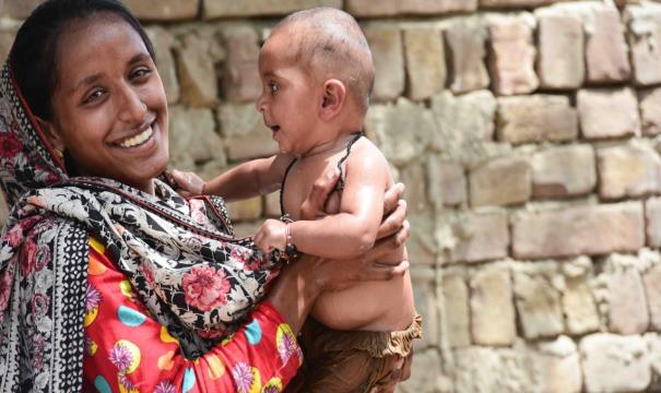 Kausar holds her healthy 7-month-old daughter.